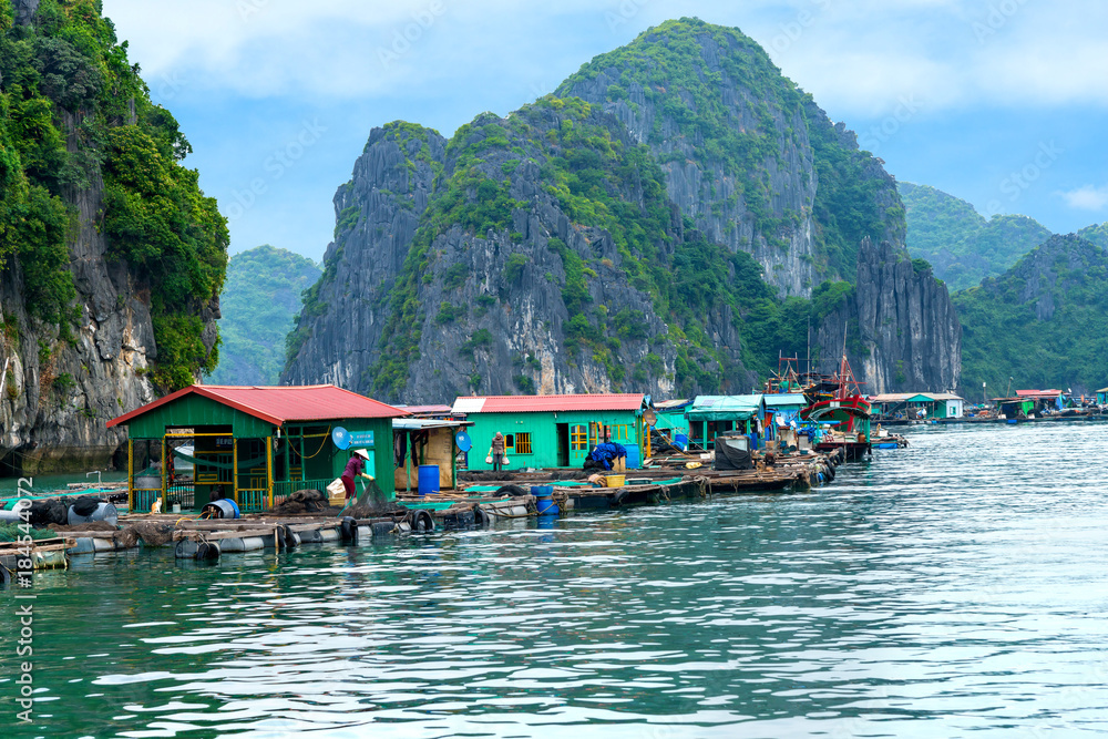 Floating fishing village and rock island in Lan Ha Bay destination beautiful sea and the beach in Vietnam, Southeast Asia. UNESCO World Heritage Site. Floating fishing village and rock island in Lan Ha Bay destination beautiful sea and the beach in Vietnam, Southeast Asia. UNESCO World Heritage Site.