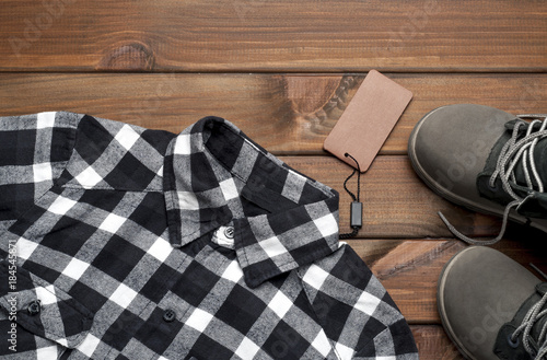 new stylish men's checkered shirt, shoes, on a brown background
