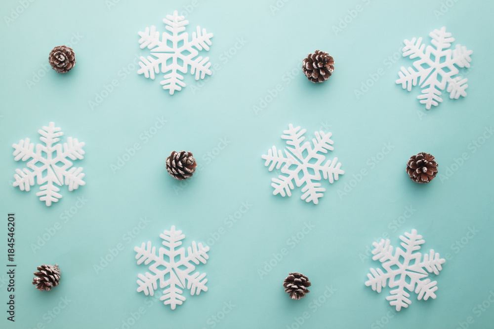 Merry Christmas and Happy New Year. Pattern foam cutter snowflake and dried pine on pastel color Merry Christmas and Happy New Year. Pattern foam cutter snowflake and dried pine on pastel color