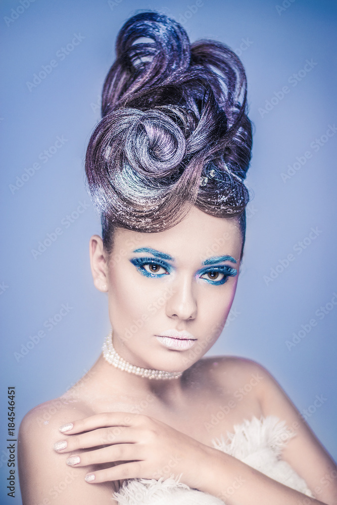 Snow Queen.Fantasy girl portrait. Winter fairy portrait.Young woman with creative silver artistic make-up.