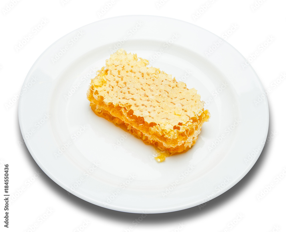 Honeycomb with honey on plate isolated white background Honeycomb with honey on plate isolated white background