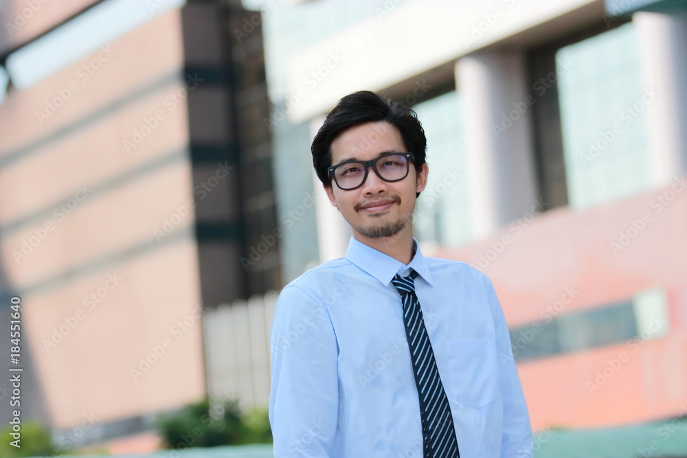 Portrait confident young Asian businessman standing against a pole. Vision business concept.Portrait confident young Asian businessman standing against a pole. Vision business concept. Portrait confident young Asian businessman standing against a pole. Vision business concept.Portrait confident young Asian businessman standing against a pole. Vision business concept.