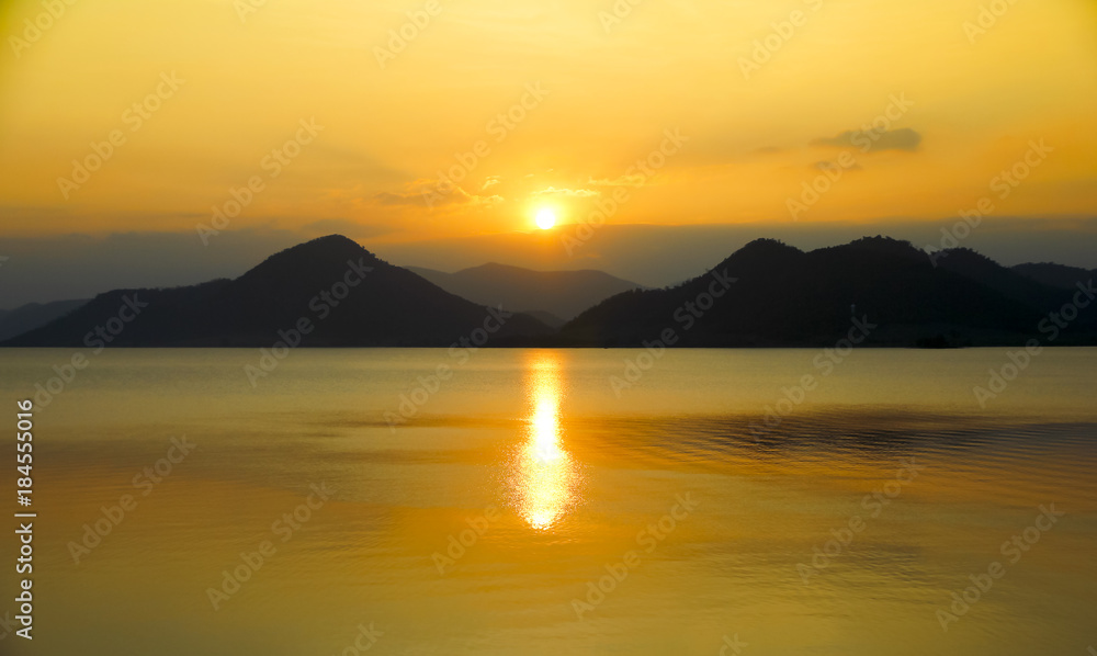sunrise over lake and mountains