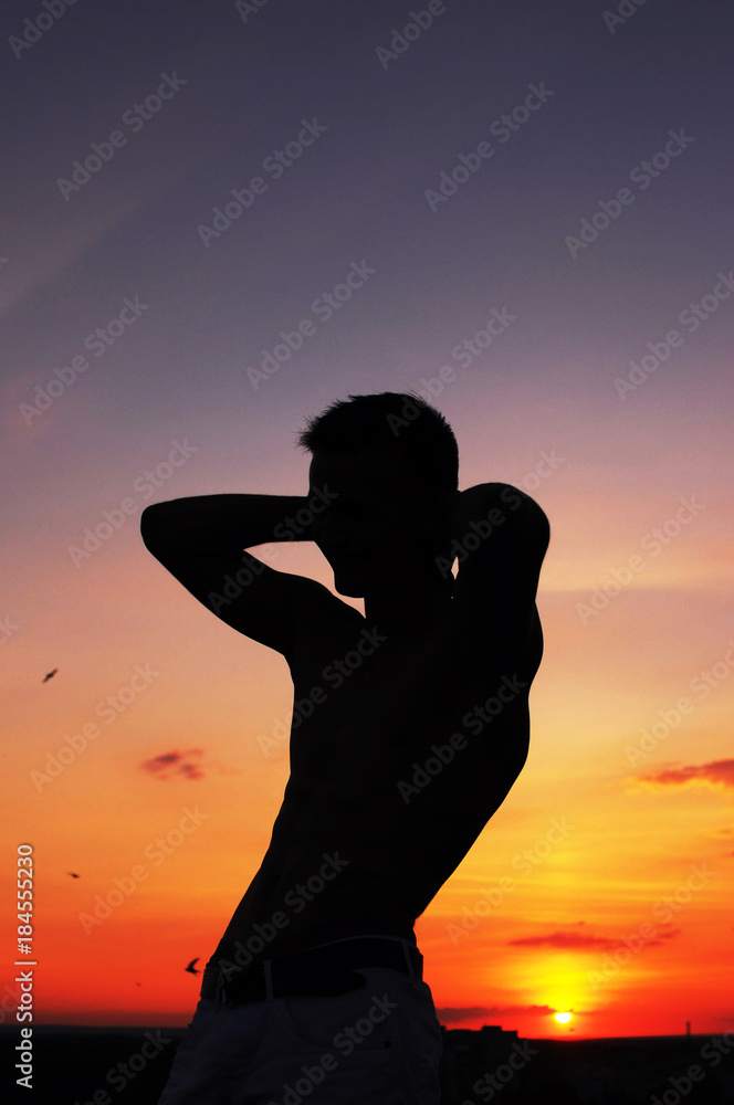 male silhouette at sunset