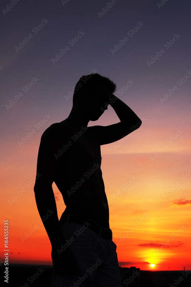 male silhouette at sunset