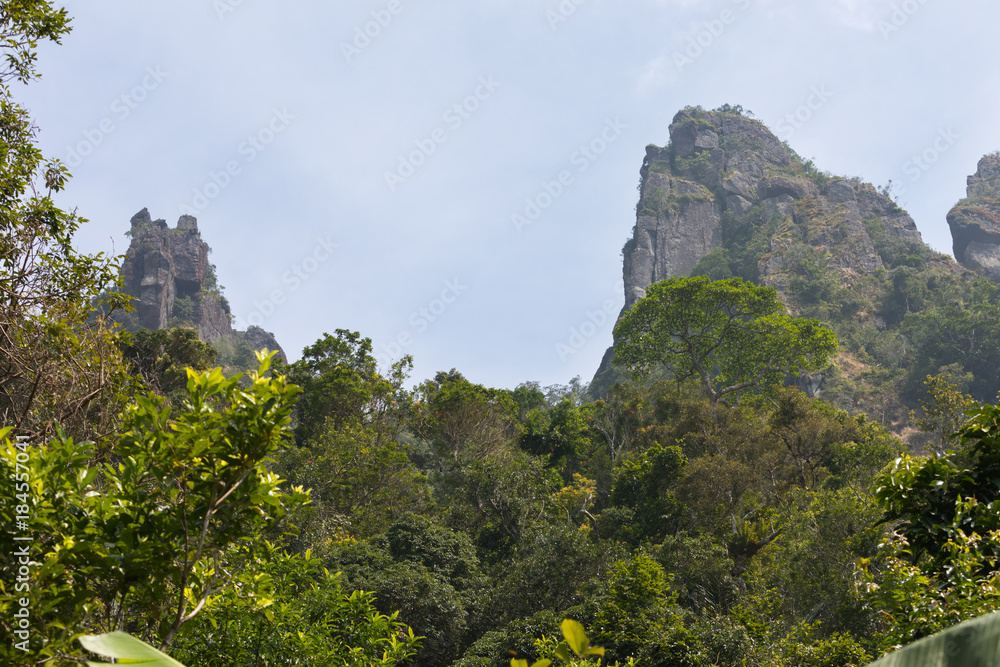 View on mountains and blue sky from rainforest in Hot Springs National Forest Park in Hainan Qixianling