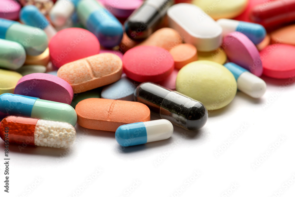 Multicolored pills on white background Multicolored pills on white background