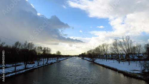 Winter Landscape with Canal Banks Covered in Snow