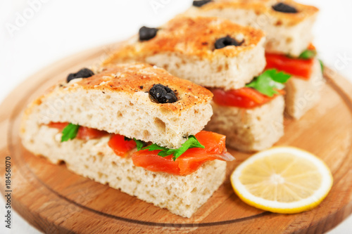 Delicious sandwiches with salted salmon and parsley closeup. Homemade whole wheat Focaccia with red fish