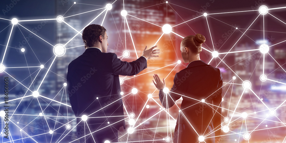 Concept of social connection and networking against night city view and partners working in cooperation Concept of social connection and networking against night city view and partners working in cooperation