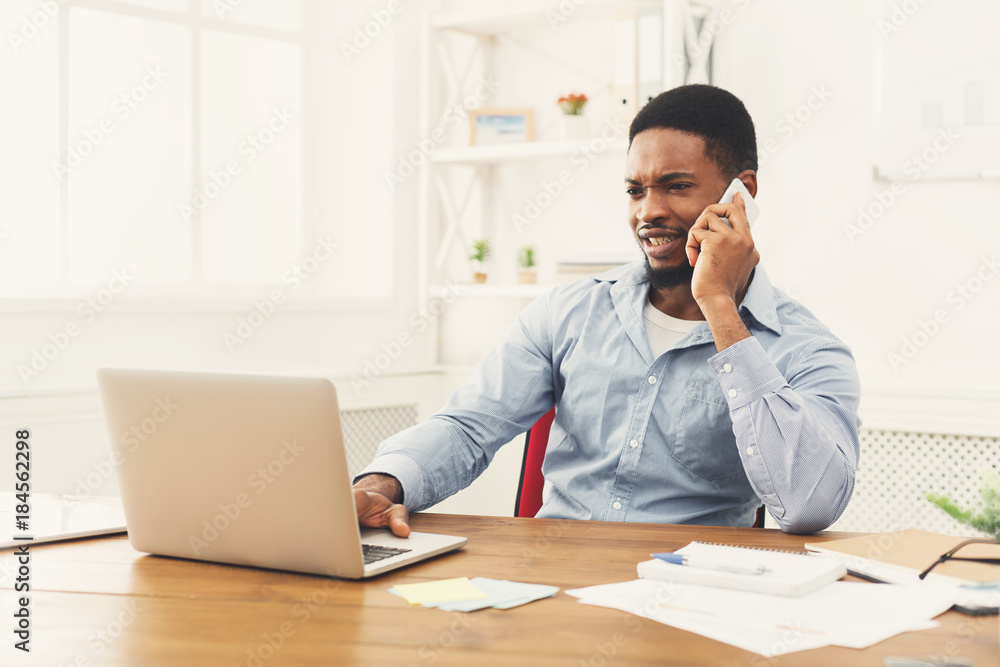 Young black businessman talking on mobile phone Young black businessman talking on mobile phone