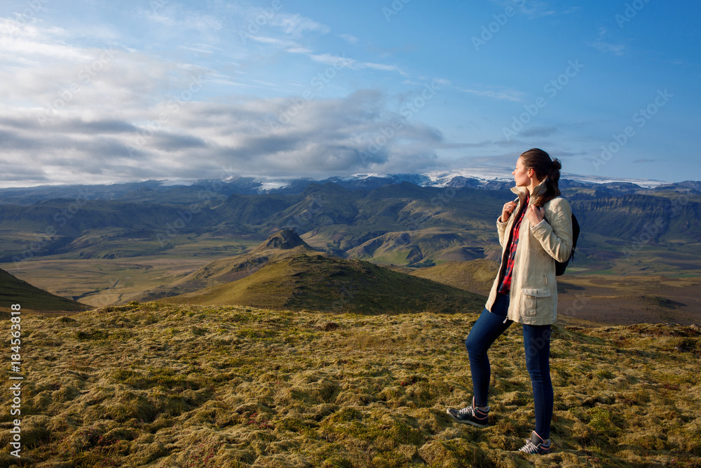 Naklejka premium Attractive girl tourist on background of mountain landscape