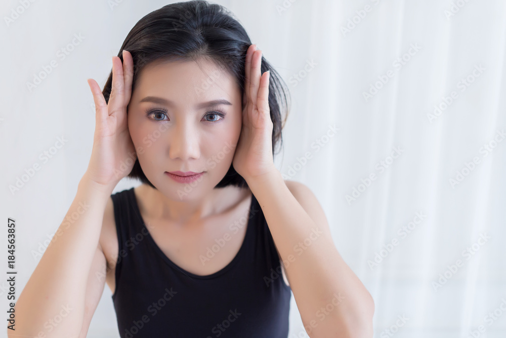 beautiful asian woman in black vest portrait with happiness action on bed with white room background beautiful asian woman in black vest portrait with happiness action on bed with white room background