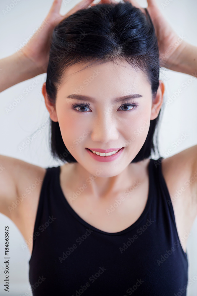 beautiful asian woman in black vest portrait with happiness action on bed with white room background beautiful asian woman in black vest portrait with happiness action on bed with white room background