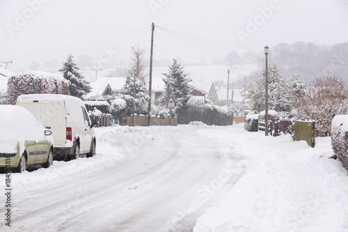 Heavy snowfall on a housing estate in the United Kingdom with roads blocked by snow and ice