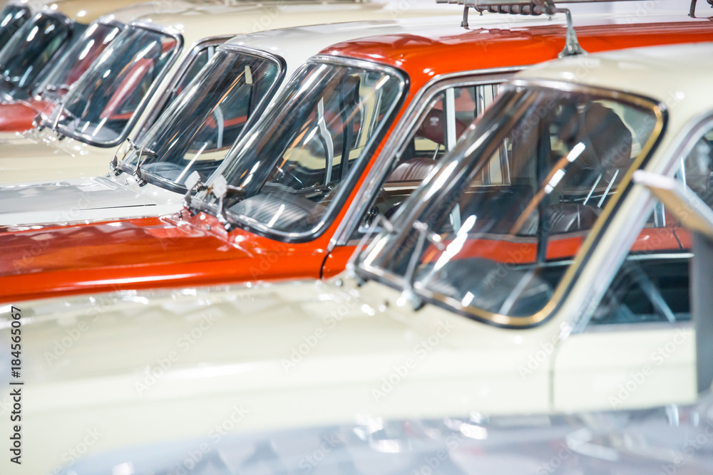 Obraz premium Red and white cars in a row on parking lot 