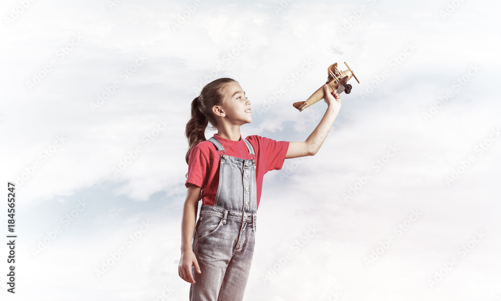 Concept of careless happy childhood with girl dreaming to become Concept of careless happy childhood with girl dreaming to become