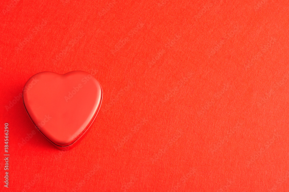Valentine's Day. A red heart shape tin isolated on a red background Valentine's Day. A red heart shape tin isolated on a red background
