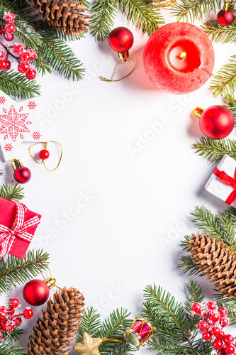 Christmas background with candle and decorations on white.