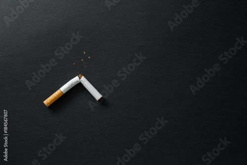 Broken cigarette on a dark background. quit Smoking