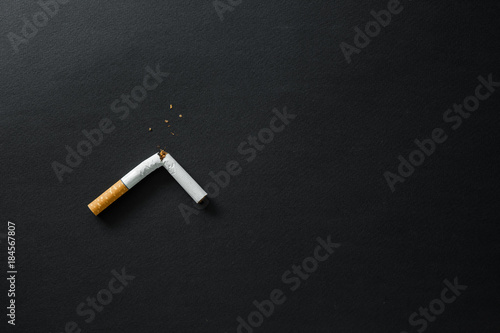 Fotografie Broken cigarette on a dark background. quit Smoking