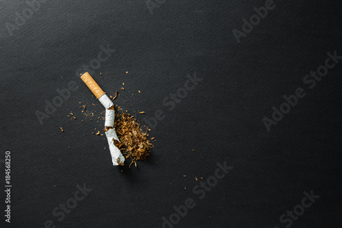 Broken cigarette on a dark background. quit Smoking