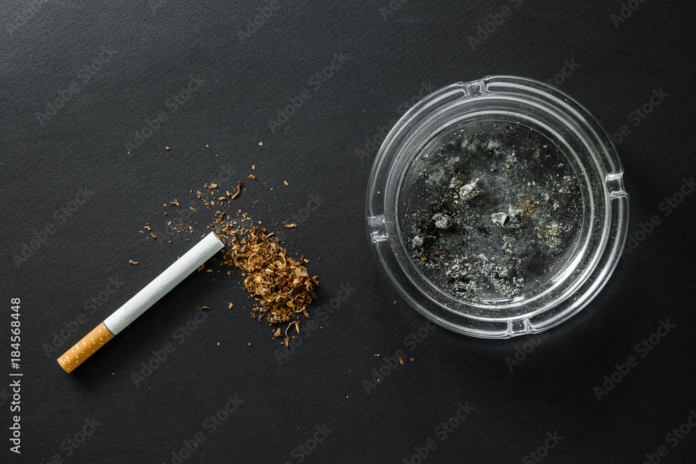 Fotografie Cigarette on a dark background. Ashtray. quit Smoking