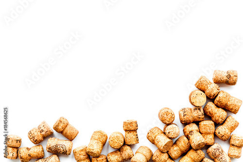 Wine bottle corks on white background top view copyspace. New Year celebration concept