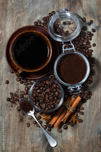 roasted coffee beans and spices on dark wooden background, concept photo, vertical top view