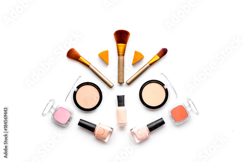 Decorative cosmetics pattern. Eyeshadows, rouge, brushes on white background top view