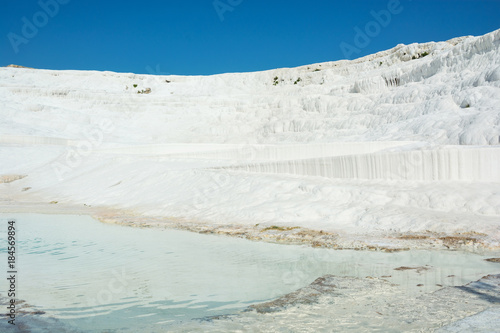 View of the Pamukkale, Turkey. Sights of Turkey - white mountains of calcareous deposits in Pammukalle. photo