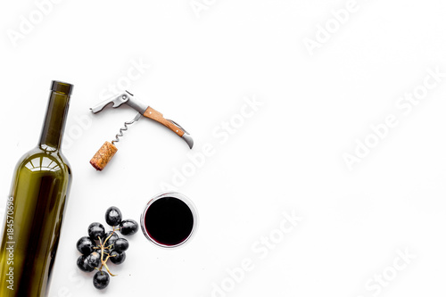 Open the wine. Corkscrew near bottle, glass, grape on white background top view copyspace