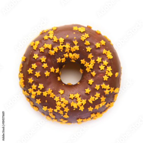 Christmas donut with chocolate icing and golden stars.