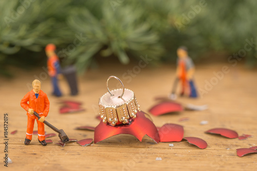 Miniature of cleaning persons and broken christmas balls