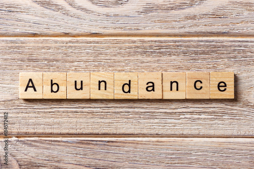 abundance word written on wood block. abundance text on table, concept photo