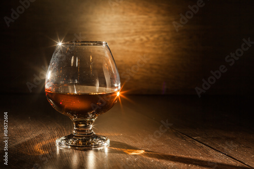 Cognac drinks glass on dark background