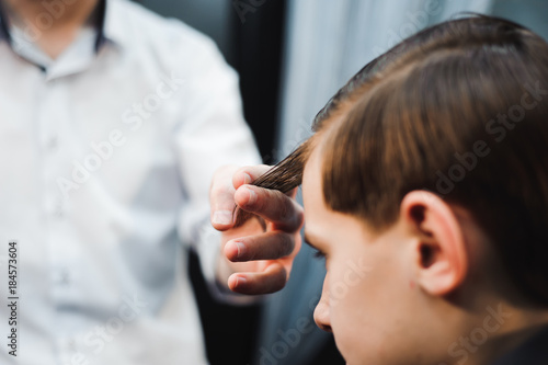 cute young boy getting a haircut