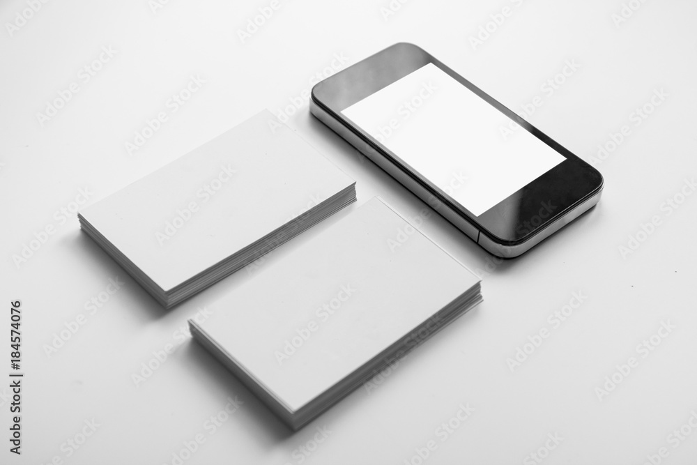 Mockup of two business cards and cell phone with blank screen Mockup of two business cards and cell phone with blank screen