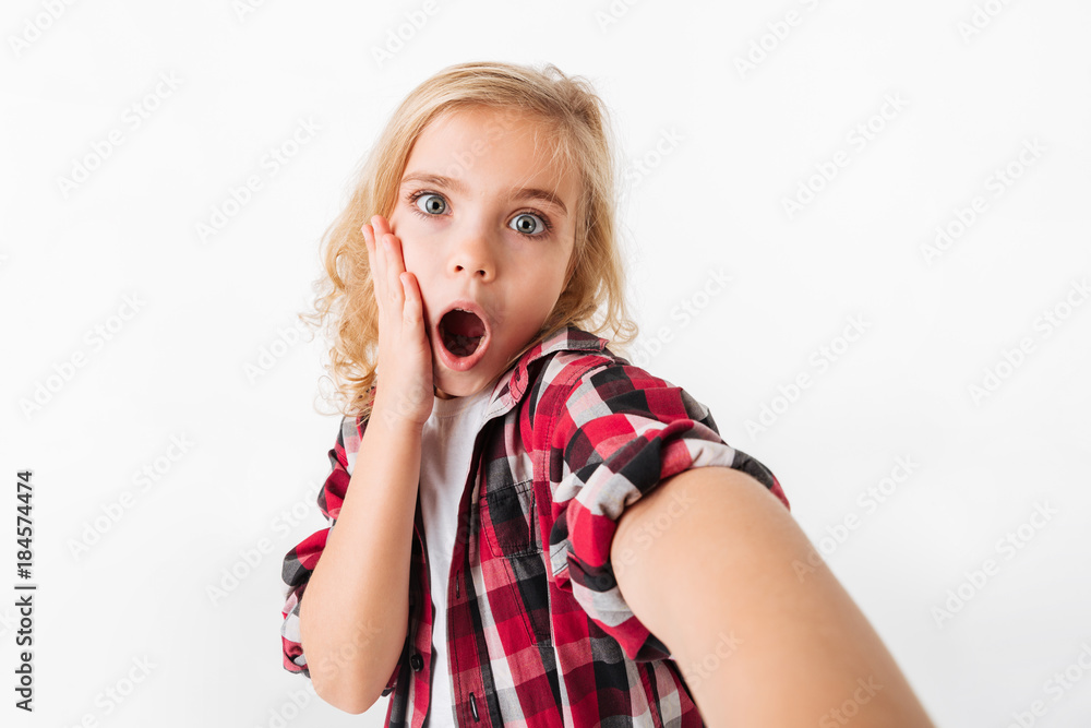 Portrait of a surprised little girl taking a selfie Portrait of a surprised little girl taking a selfie