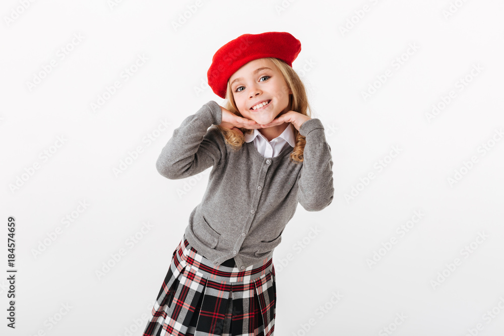 Portrait of a smiling little schoolgirl dressed in uniform posing Portrait of a smiling little schoolgirl dressed in uniform posing