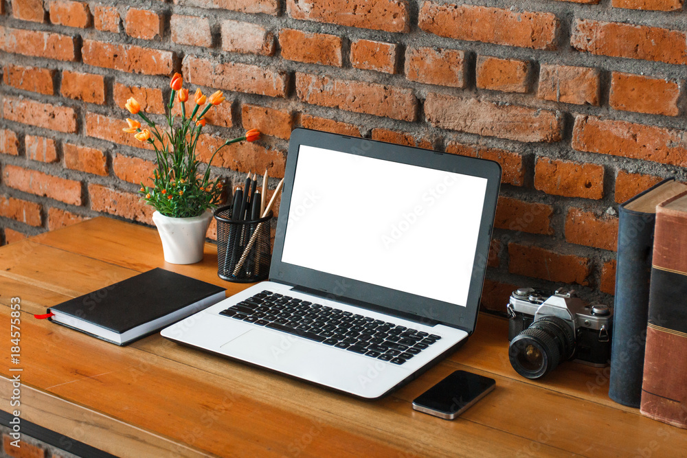 working space on wooden table and brick wall background working space on wooden table and brick wall background