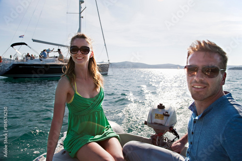 Man and woman in yacht dinghy