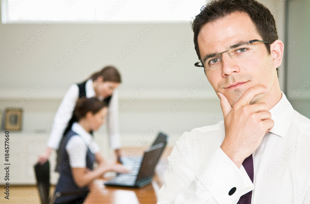 Thoughtful business man looks to camera Thoughtful business man looks to camera