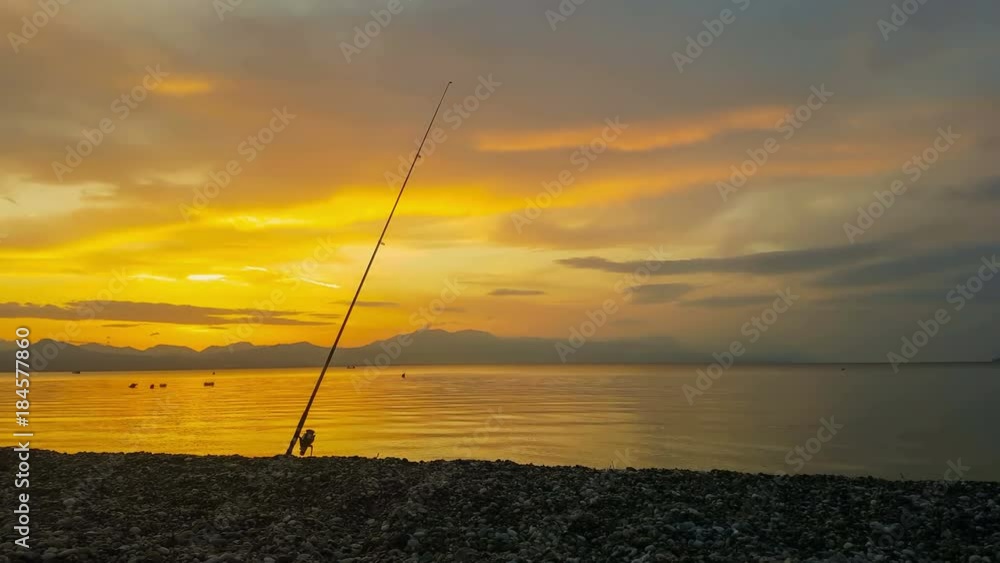 Fishing rod against the sunset at Loutraki in Greece.
Fishing rod against the sunset at Loutraki in Greece.