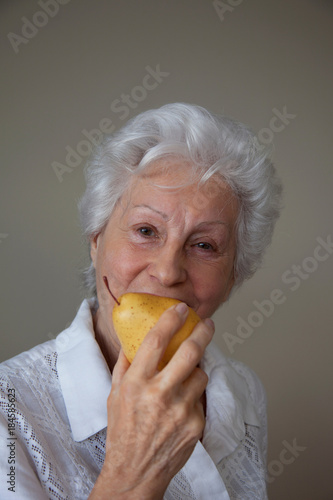 Senior Woman eating a pear