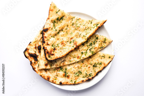 Garlic and coriander naan served in a plate, it's a type of Indian bread or roti flavoured with garlic

