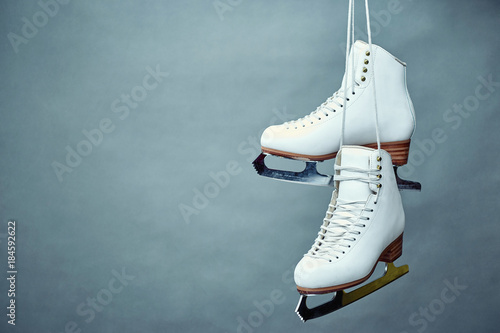 Women's skates with laces on a gray background.