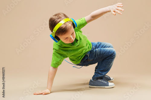 break dance kids. little break dancer showing his skills in dance studio. Hip hop dancer boy performing over studio background