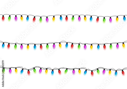 Christmas glowing lights on white background. Garlands with colored bulbs. Xmas holidays. Christmas greeting card design element. New year,winter.