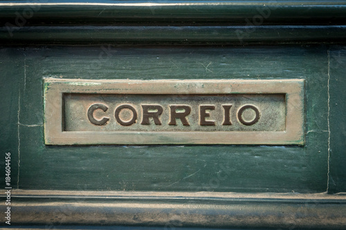 Old rusty mailbox with the word "letters" writen in portugese "correio"